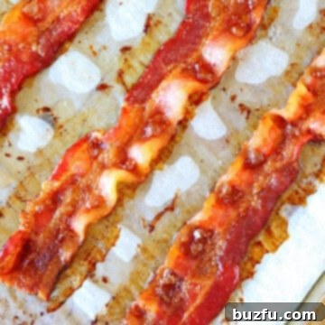 Perfect Oven Baked Bacon 2 Crispy bacon on parchment paper.