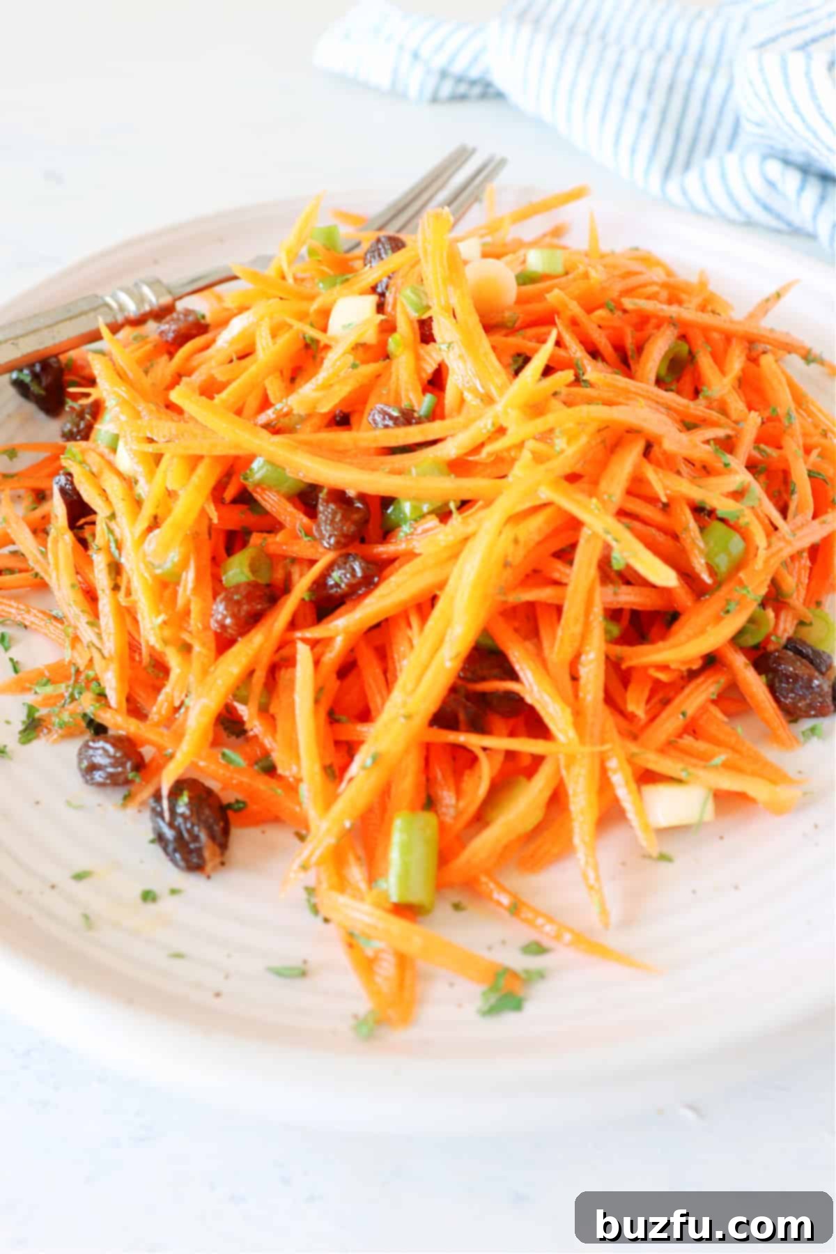Carrot Salad with Raisins Carrot salad served on a plate, garnished and ready to eat.
