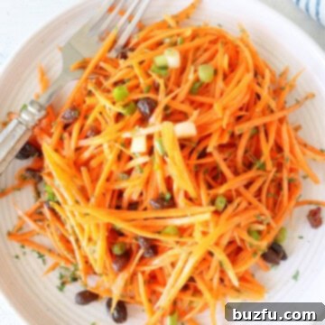 Carrot Salad Carrot salad on a plate with fork, showing the final dish.
