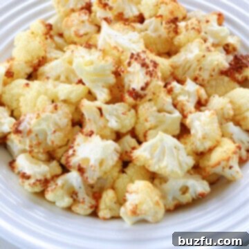 Air fried cauliflower florets on a plate, ready to be served.