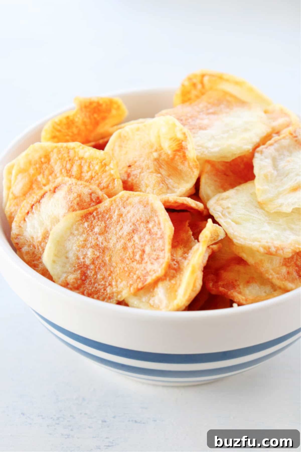 Air Fryer Potato Chips recipe Crispy potato chips served in a bowl, fresh from the air fryer.
