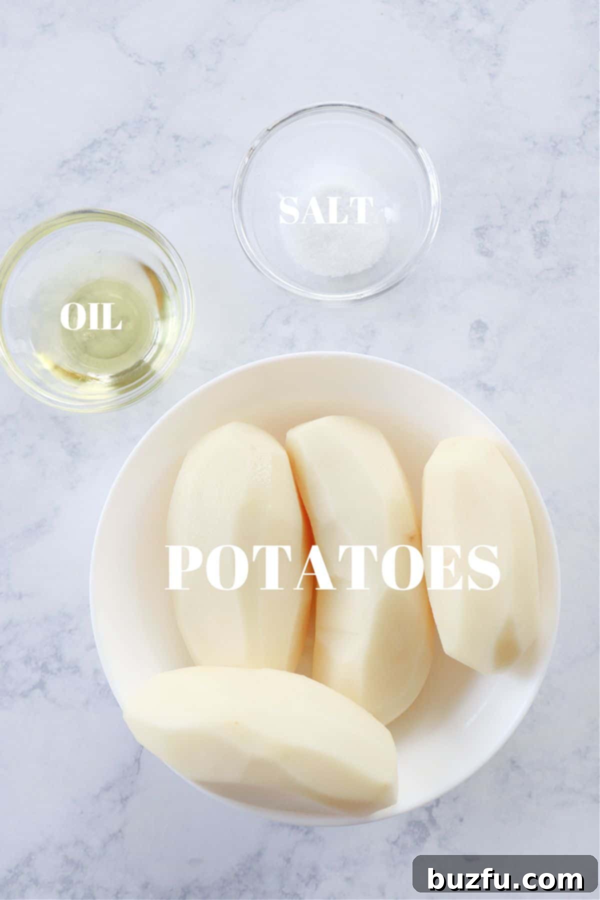 Air Fryer Potato Chips ingredients Ingredients for air fryer potato chips laid out on a marble board.