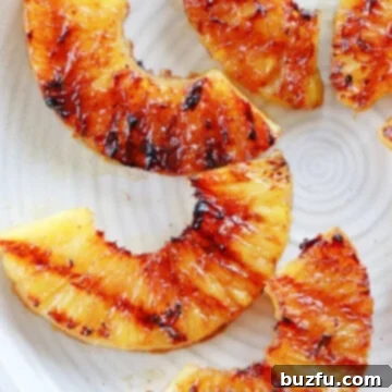 Grilled pineapple slices on a plate.