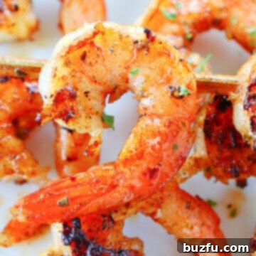 Grilled shrimp skewers on a plate, beautifully cooked and ready to eat.