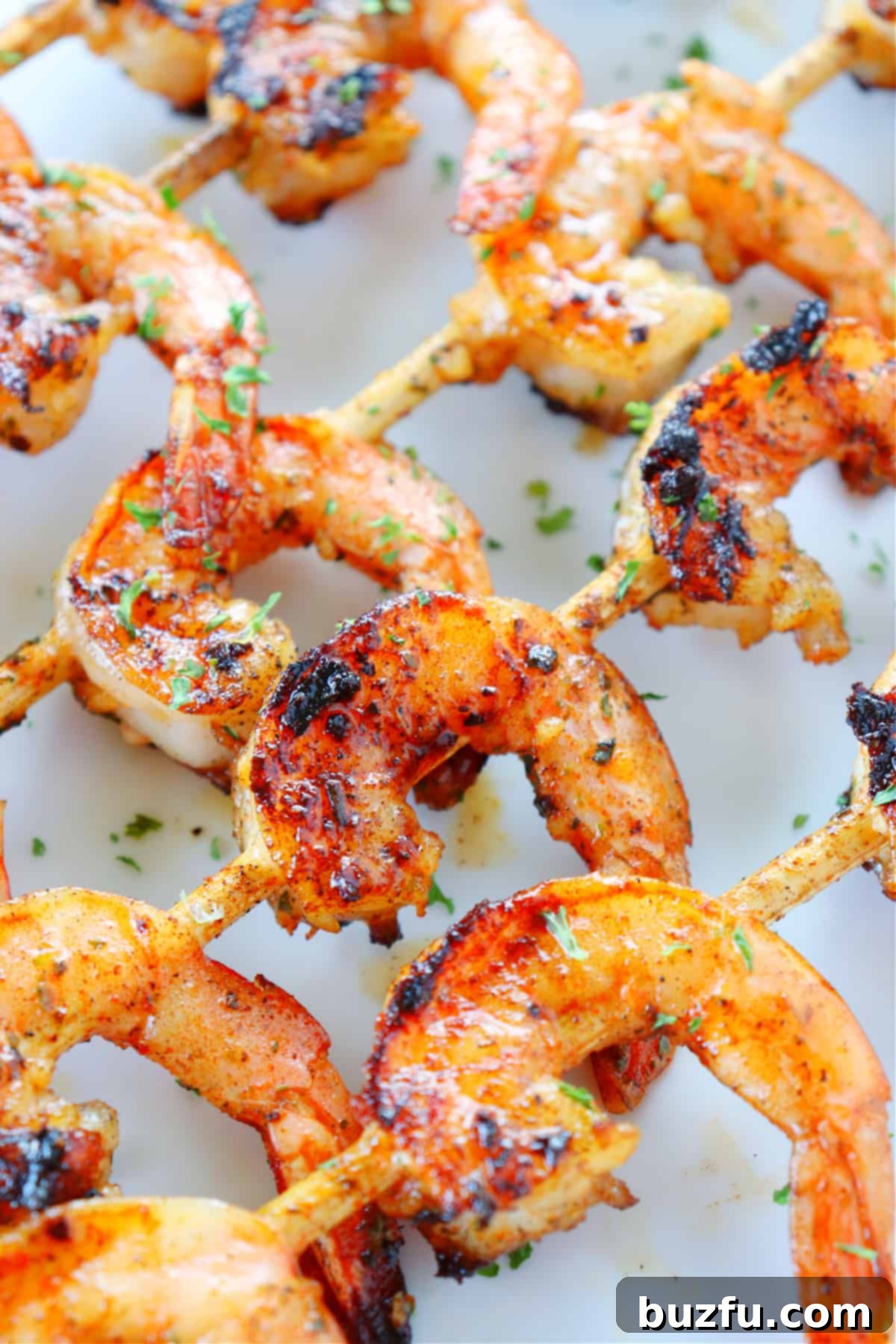 Plated grilled shrimp with a side of fresh lemon wedges and herbs, ready to be enjoyed.