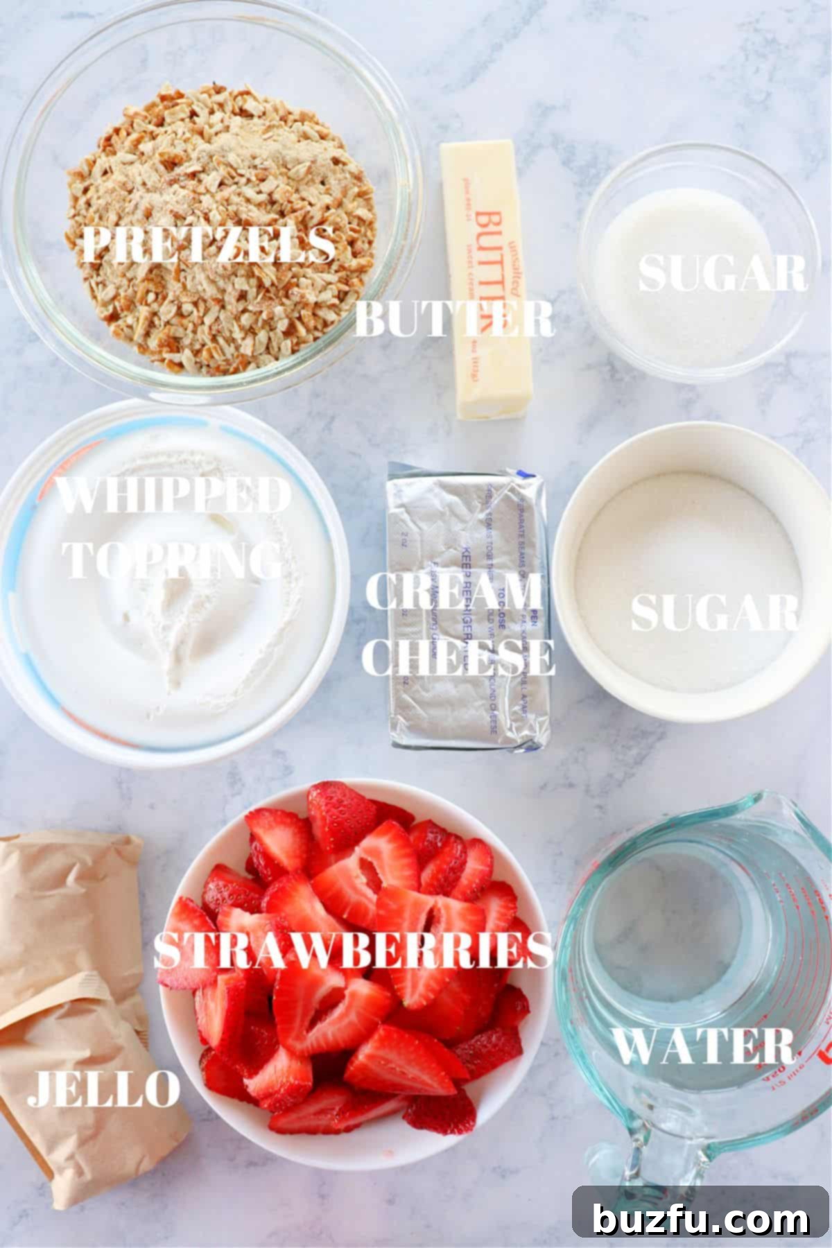 Strawberry Pretzel Salad ingredients All the necessary ingredients for strawberry pretzel salad laid out on a elegant marble board.