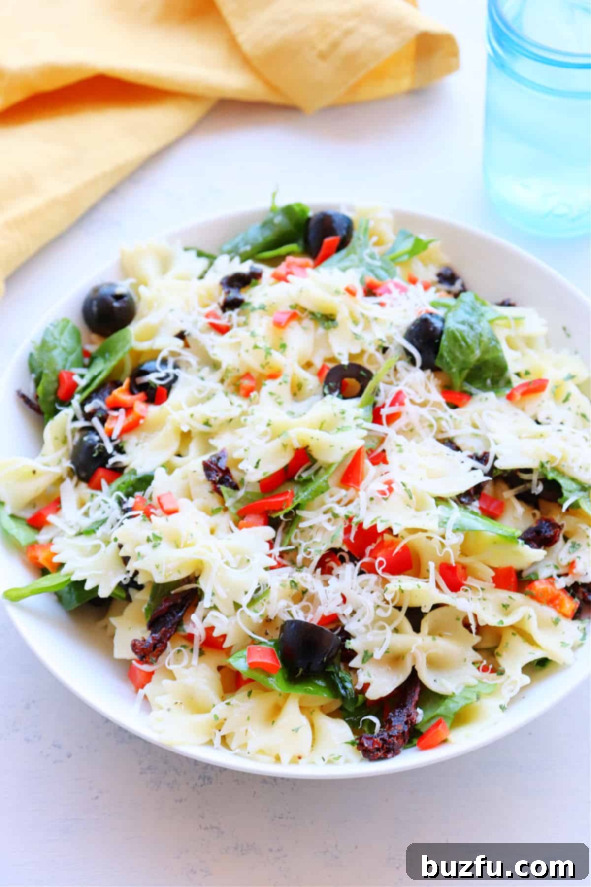 Easy and Delicious Tuscan Pasta Salad Recipe Freshly prepared Tuscan Pasta Salad in a white serving bowl, ready to be enjoyed.