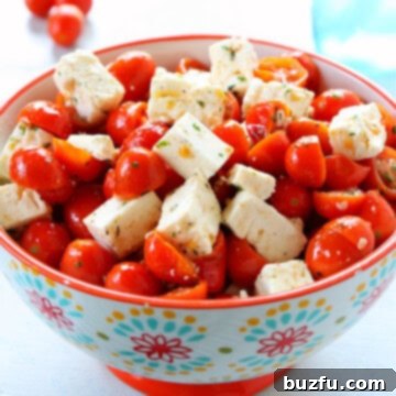 Vibrant Tomato Feta Medley 3 Tomatoes and feta salad in a flower bowl.