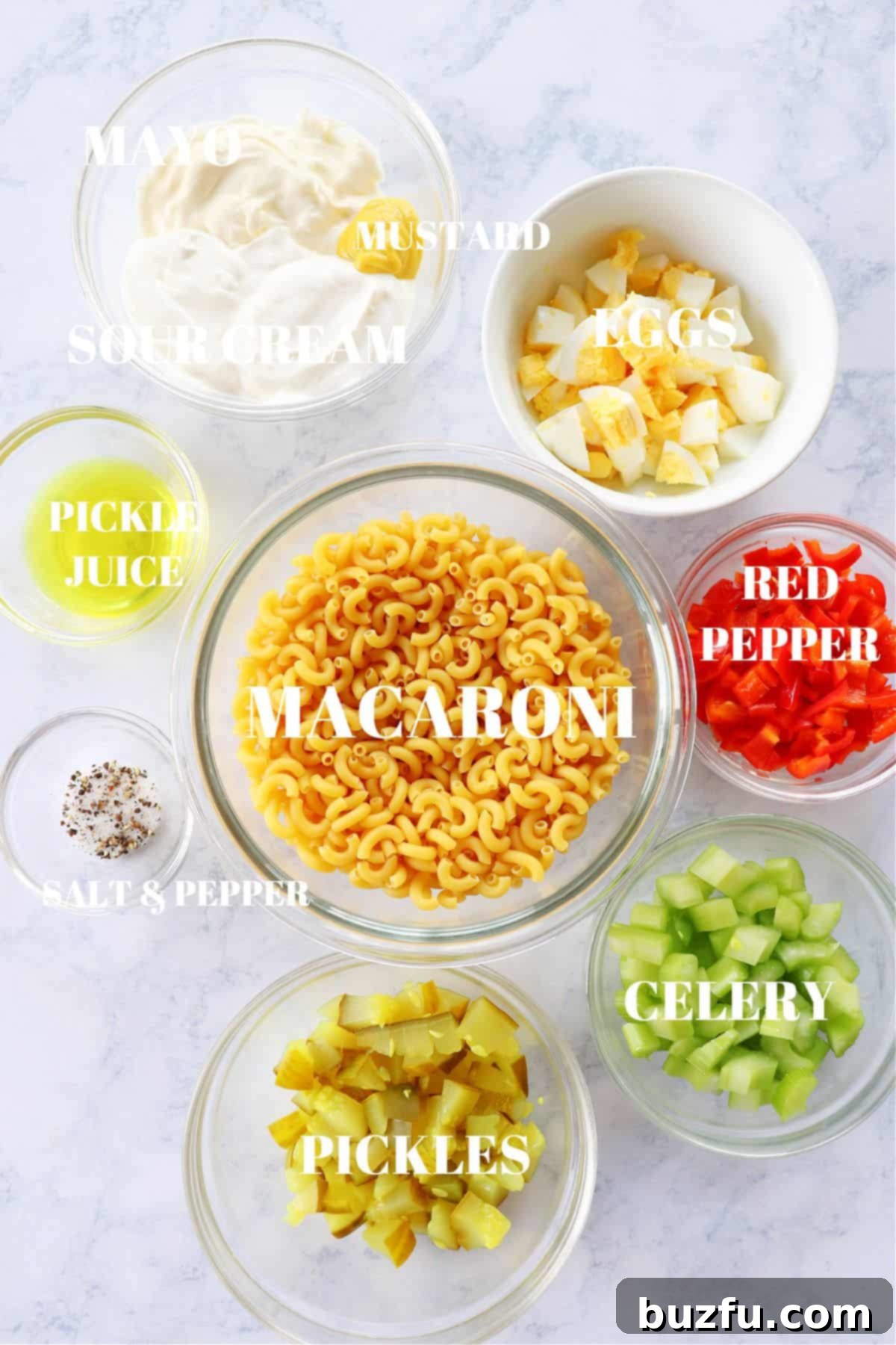 Macaroni Salad Ingredients Breakdown A selection of fresh ingredients for macaroni salad laid out on a wooden board.