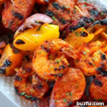 Skewers with shrimp and sausage on a plate.