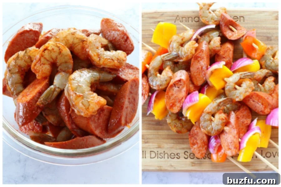 Raw shrimp, sliced sausage, and chopped vegetables tossed with seasoning in a bowl, with some already threaded onto wooden skewers.
