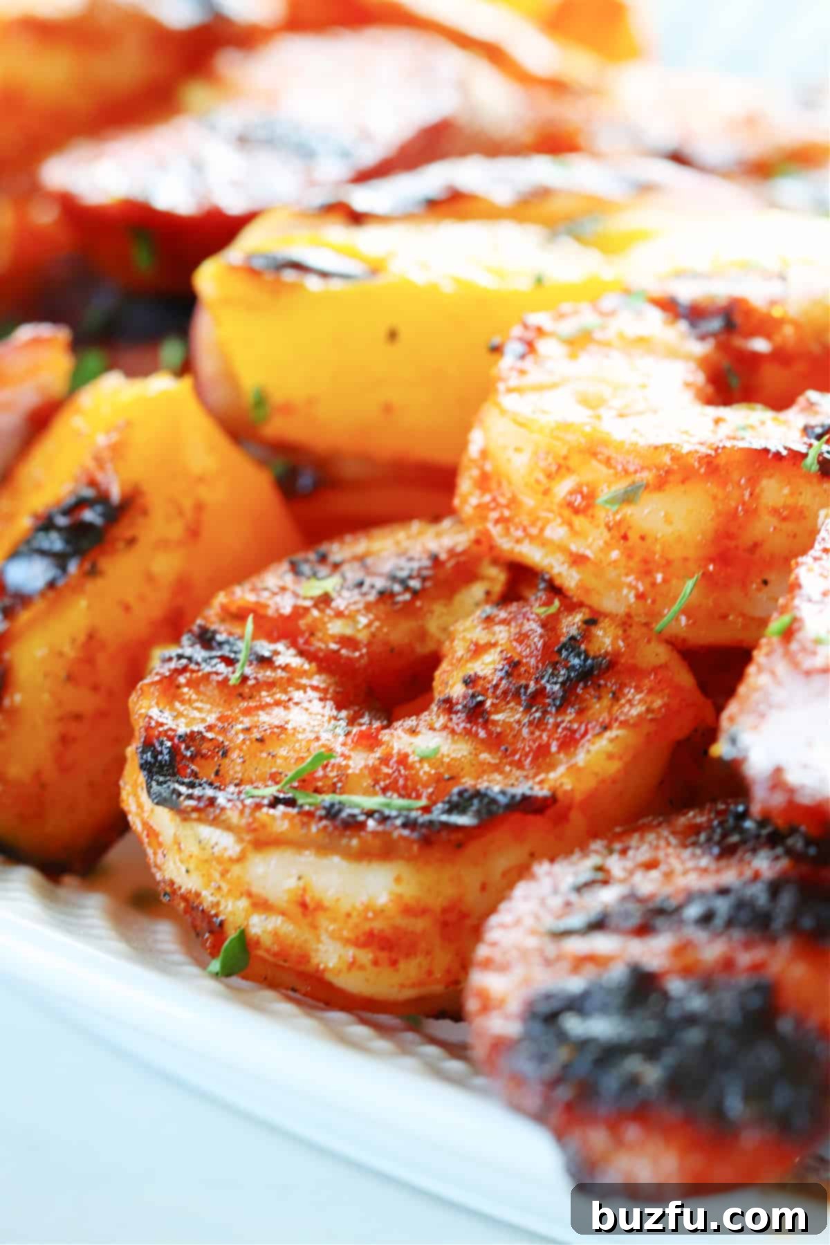 Close-up shot of grilled shrimp and sausage skewers showcasing their beautiful char marks and vibrant colors.