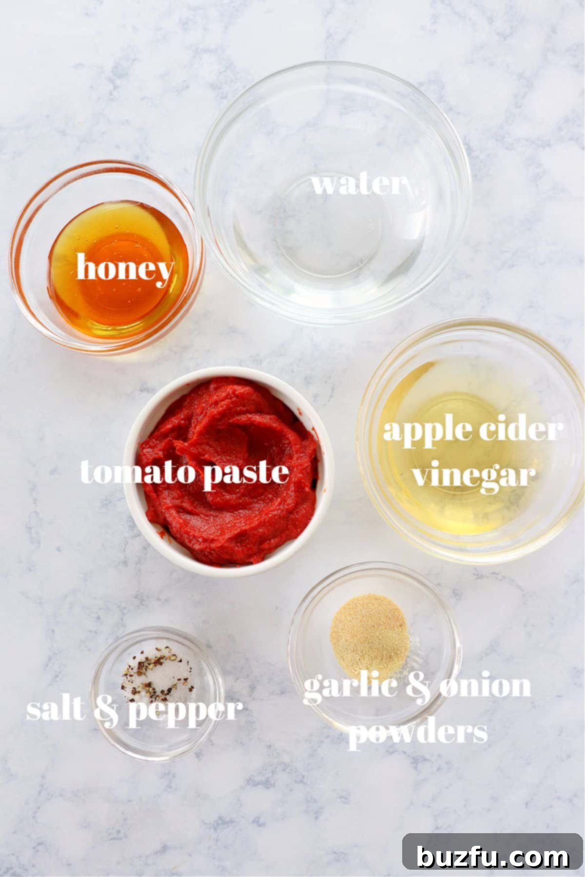 Homemade Ketchup Ingredients Key ingredients for homemade ketchup laid out on a rustic wooden board.