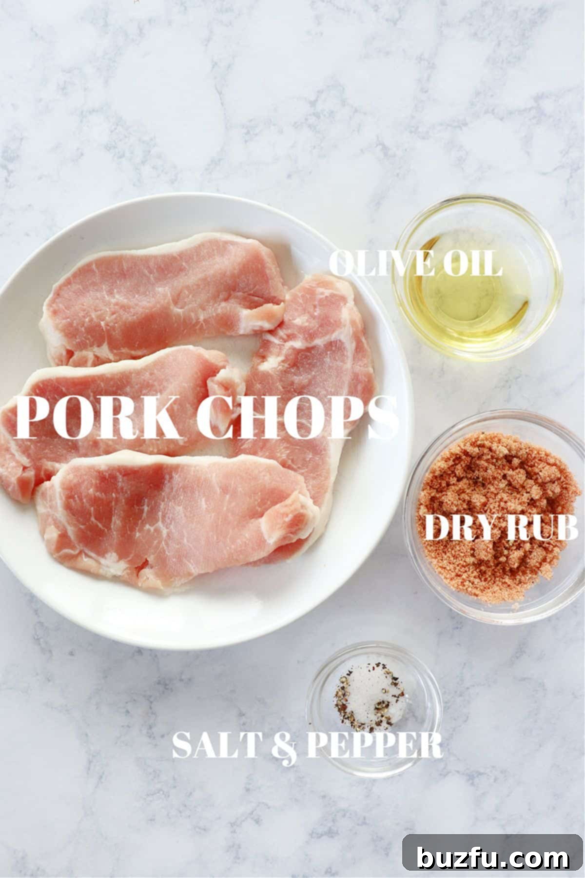 Simple Ingredients for Air Fryer Pork Chops A cutting board displays the simple ingredients for air fryer pork chops: boneless chops, olive oil, and a bowl of dry rub.