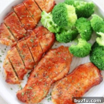 Crispy Air Fryer Pork Chops 3 Pork chops and broccoli on a plate.