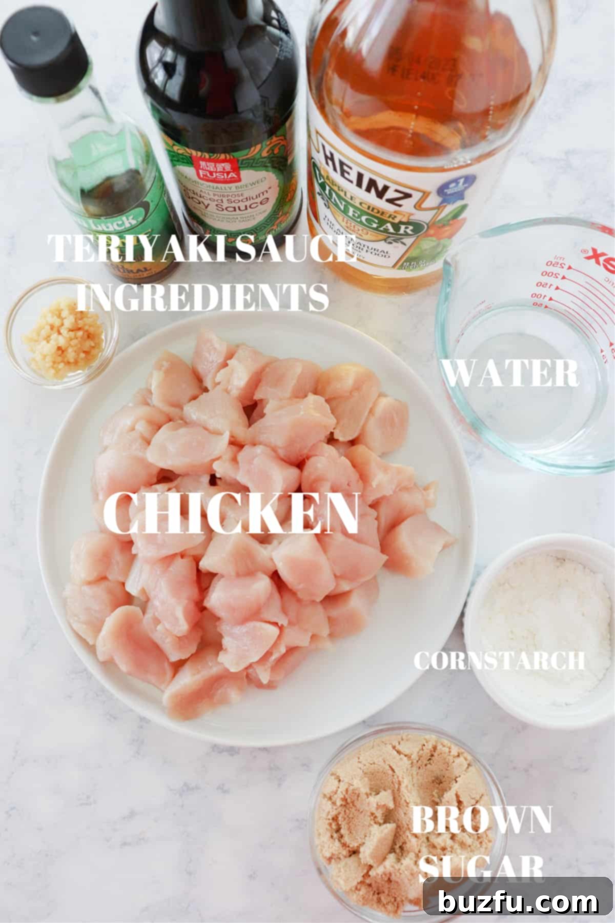 Ingredients for Instant Pot teriyaki chicken laid out on a wooden board: chicken, soy sauce, brown sugar, garlic, apple cider vinegar, sesame oil, cornstarch, salt, pepper, and water.