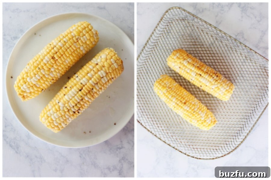 Prepared corn on the cob on an air fryer rack next to a plate with a cooked cob.