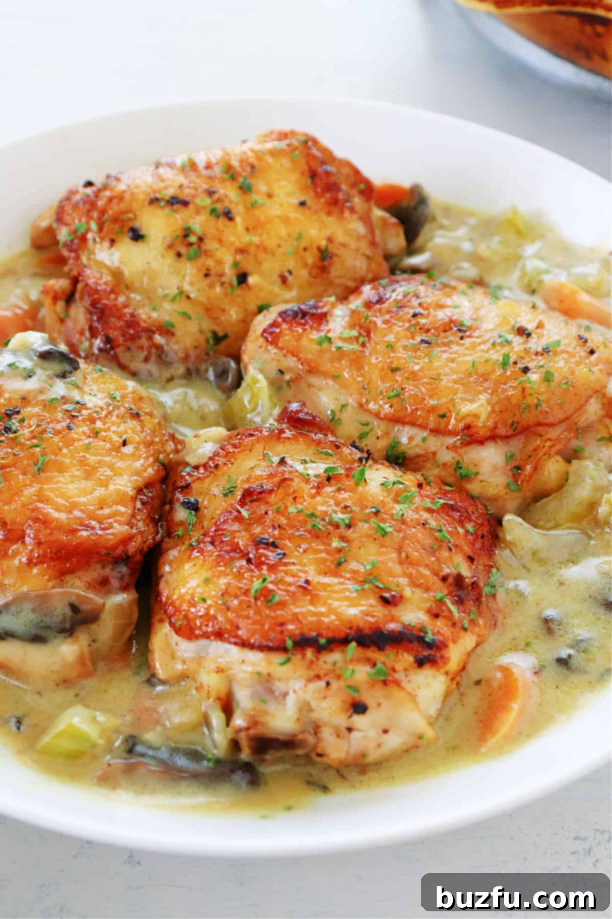 How to make chicken fricassee. Chicken thighs with sauce in a bowl.