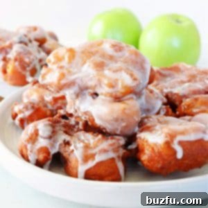 A delicious stack of apple fritters on a white plate, showcasing their perfect glaze and crispy texture.