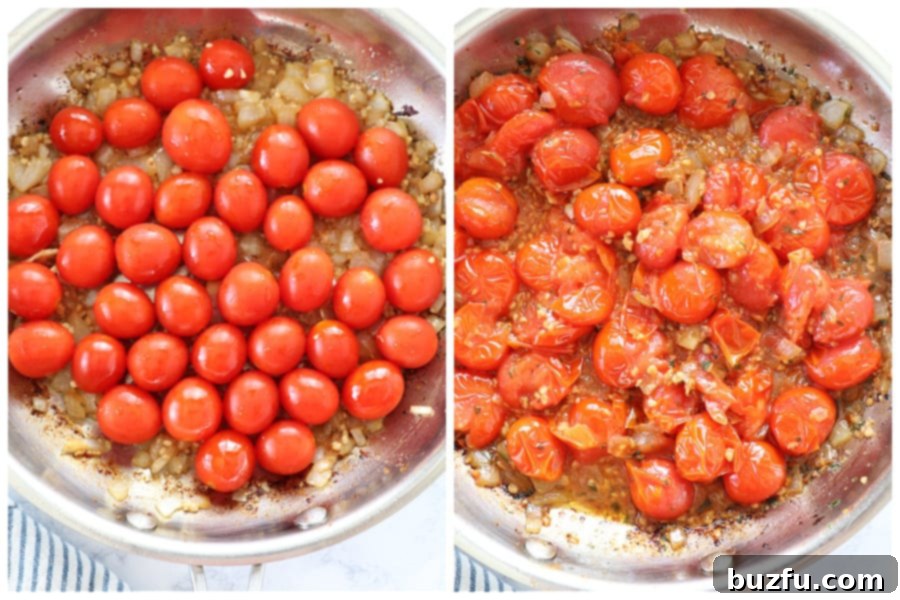 Bright red cherry tomatoes cooking in a skillet with sautéed onions and garlic, beginning to burst and form a sauce.
