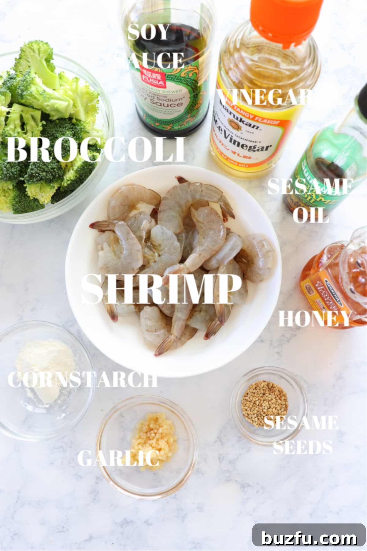 Fresh ingredients for shrimp and broccoli stir fry laid out on a wooden board.