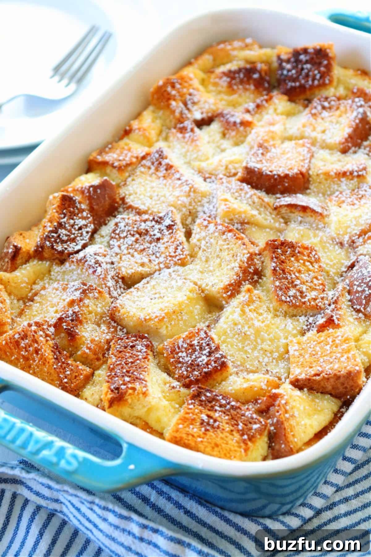 Golden brown bread pudding in a casserole dish, ready to serve.