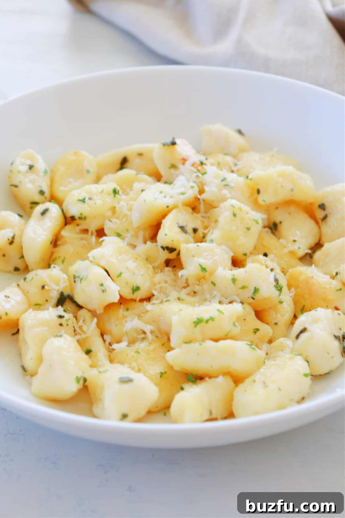 Homemade Ricotta Gnocchi from Scratch Ricotta gnocchi served in a pasta bowl, garnished with herbs and cheese.
