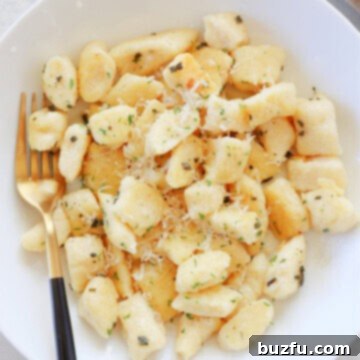 Pillowy Ricotta Gnocchi 3 Gnocchi in a white bowl.