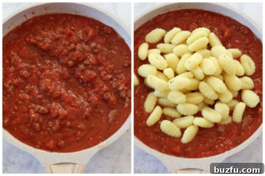 A large skillet containing a vibrant red sauce with crushed tomatoes and tender gnocchi mixed in, ready for the next step.