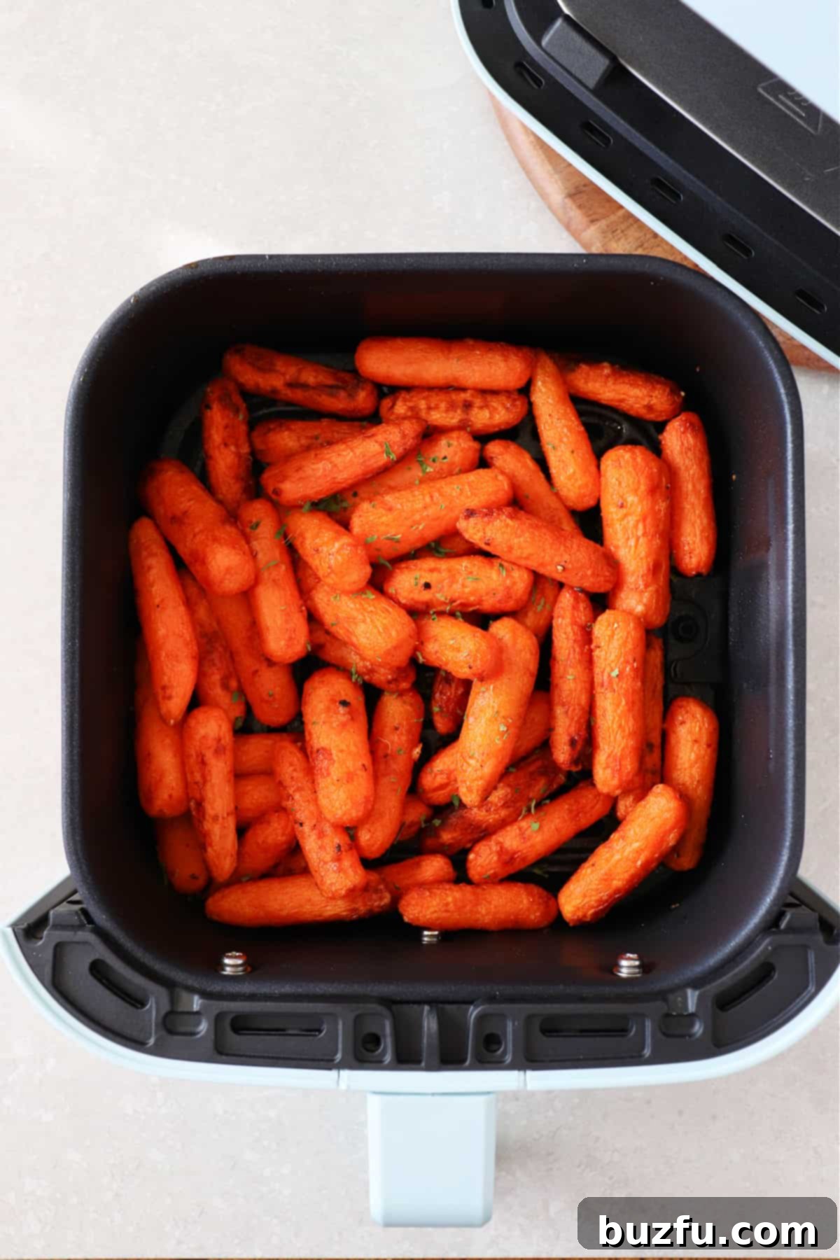 Baby carrots in the air fryer basket.