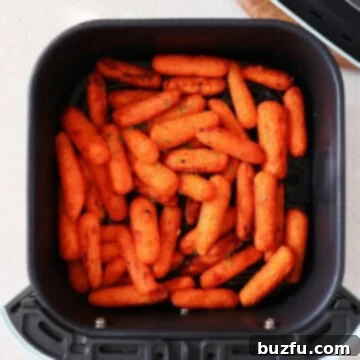 Baby carrots in the air fryer basket.