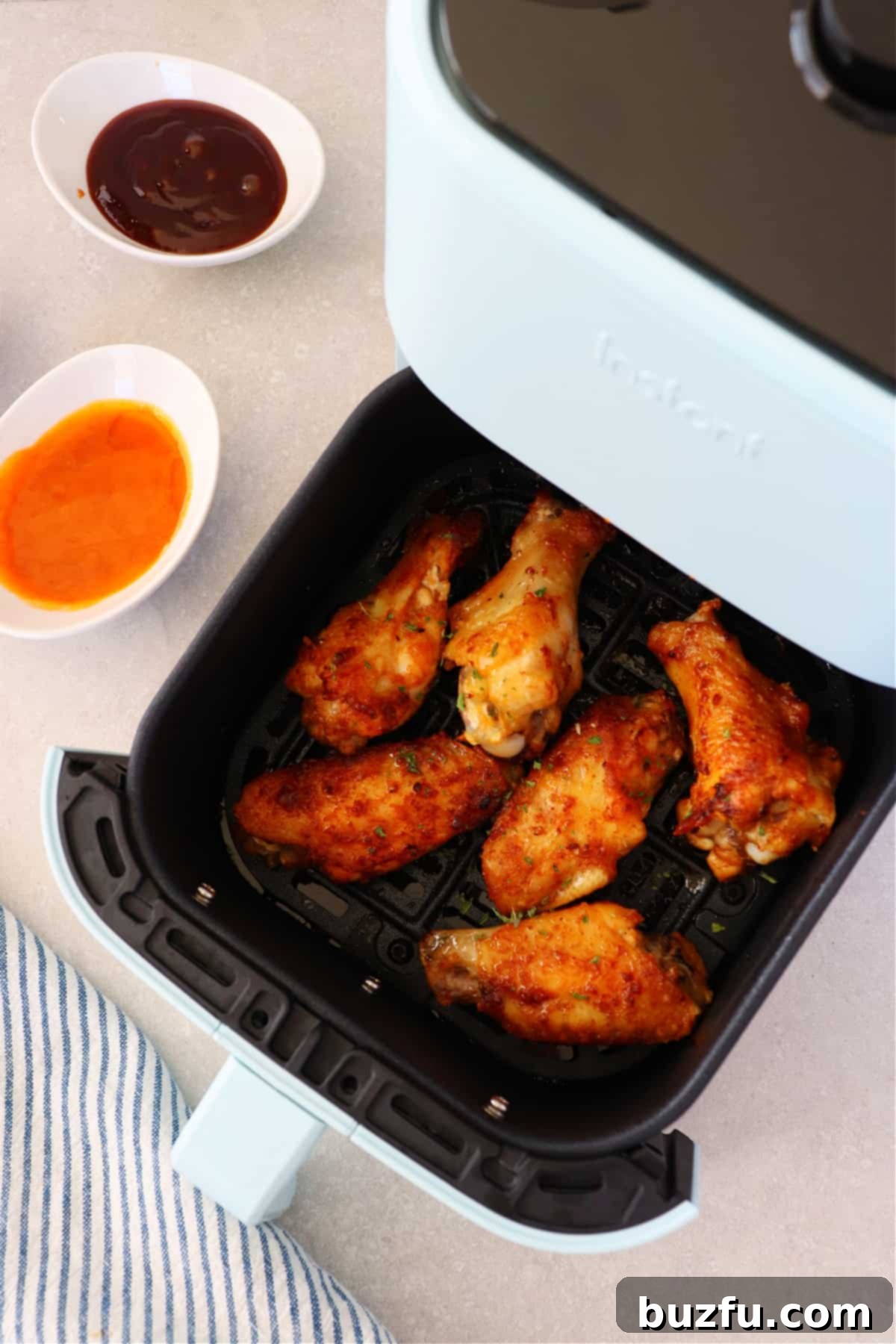 Air Fryer Chicken Wings recipe Crispy golden-brown chicken wings perfectly cooked in an air fryer basket, ready to be served.