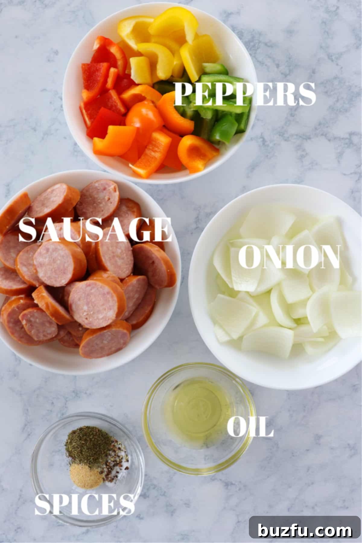 Air Fryer Sausage and Peppers recipe ingredients Ingredients for air fryer sausage on a marble board.
