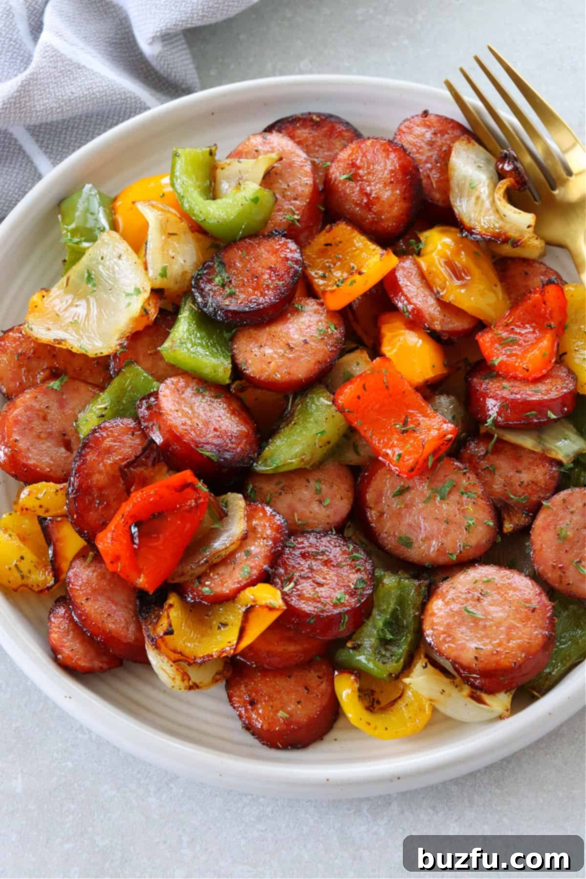 Air Fried Sausage, Peppers and onions Sausage and veggies on a plate.