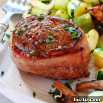 Filet mignon with roasted vegetables on a plate.