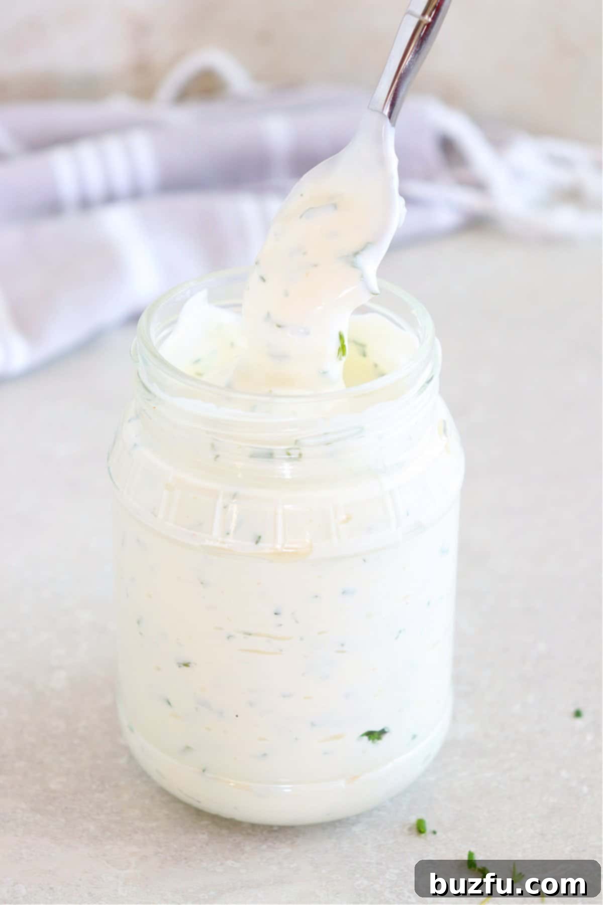 Homemade Ranch Dressing Recipe Ranch dressing in a glass jar with spoon.