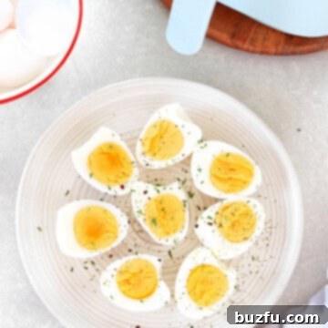 Hard boiled eggs on a plate next to the air fryer.