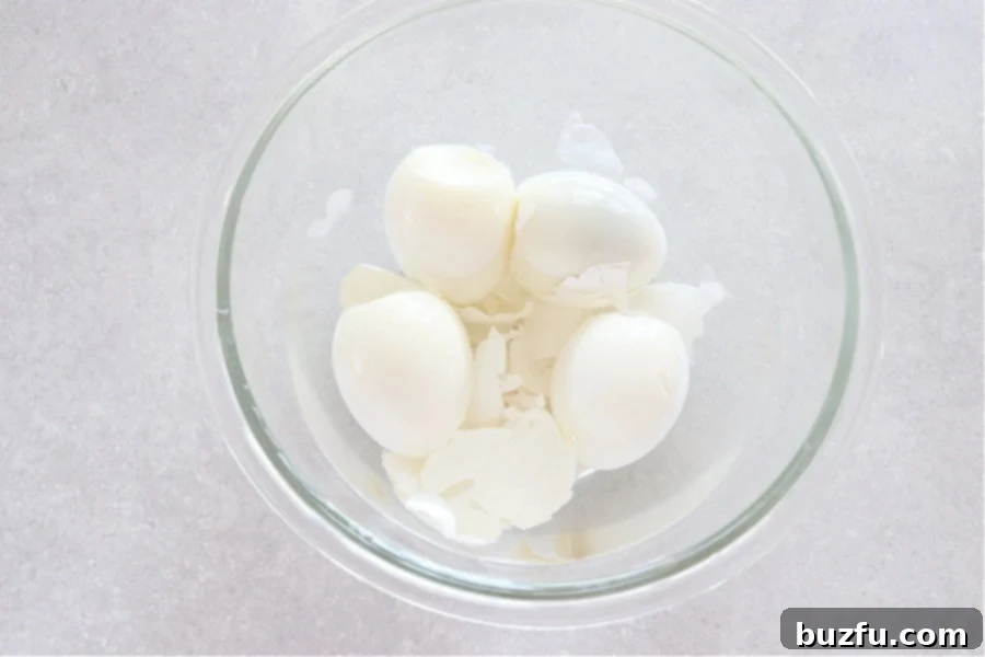 Peeled eggs in a glass with water.