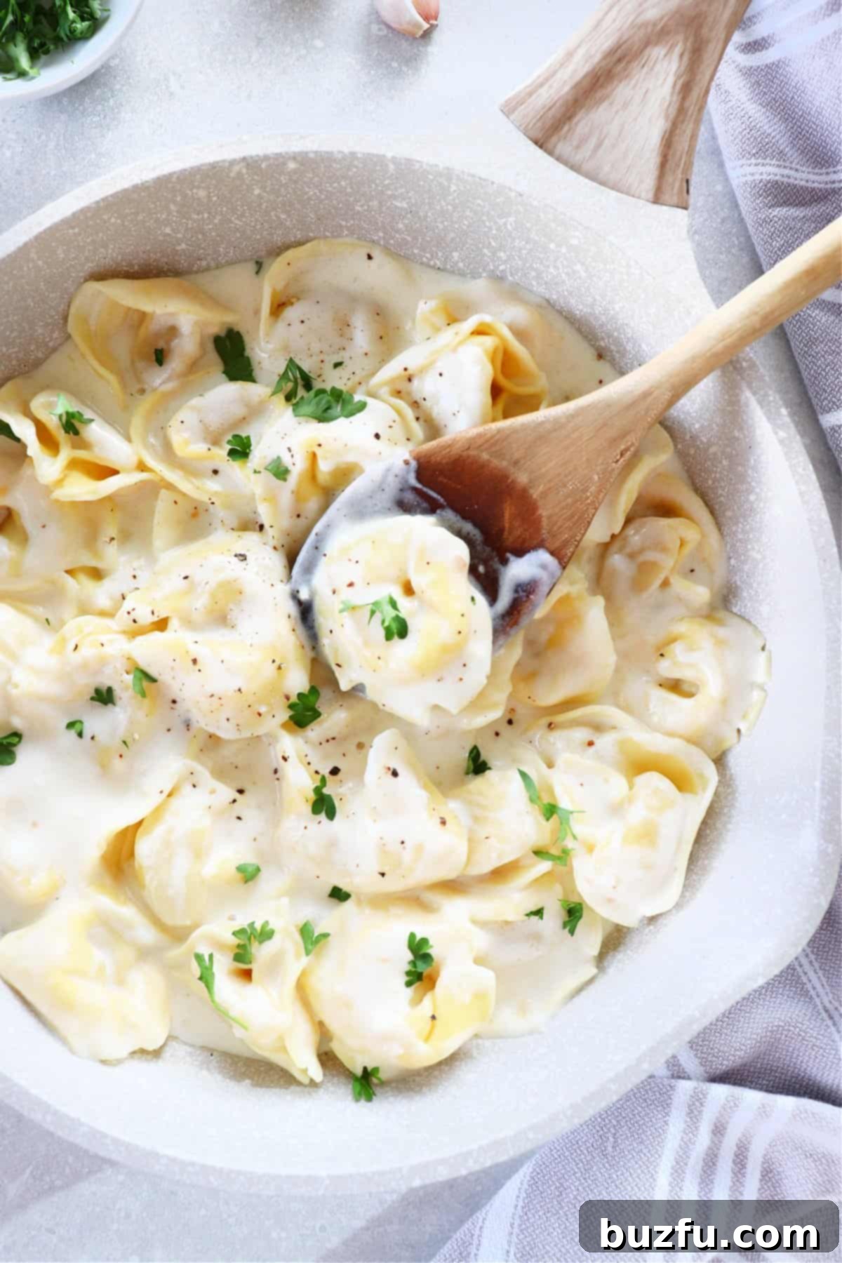 Creamy Tortellini Alfredo served in a large pan, ready to eat.