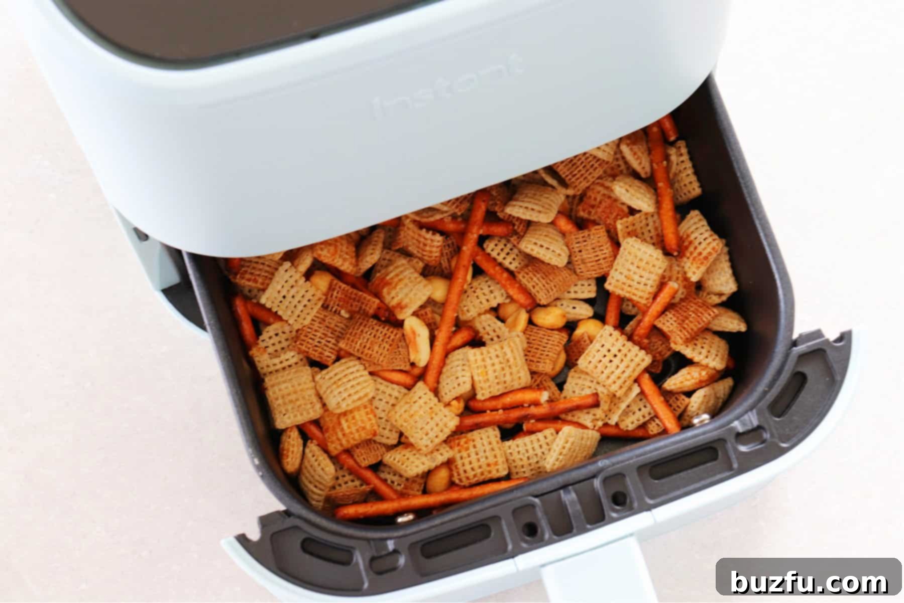 Party mix in the air fryer basket.