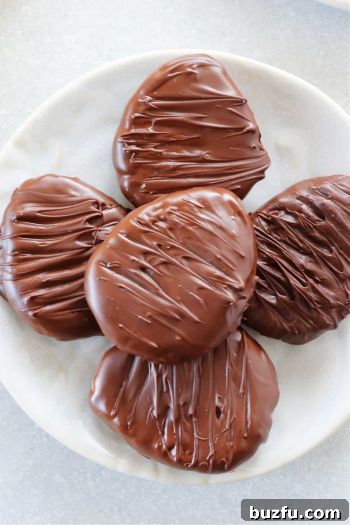 Reese's Peanut Butter Eggs Copycat Display Chocolate covered peanut butter eggs neatly arranged on a cream plate, ready for serving.