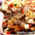 A generously sized, golden-brown Perfect Breakfast Casserole in a baking dish, brimming with delicious ingredients.