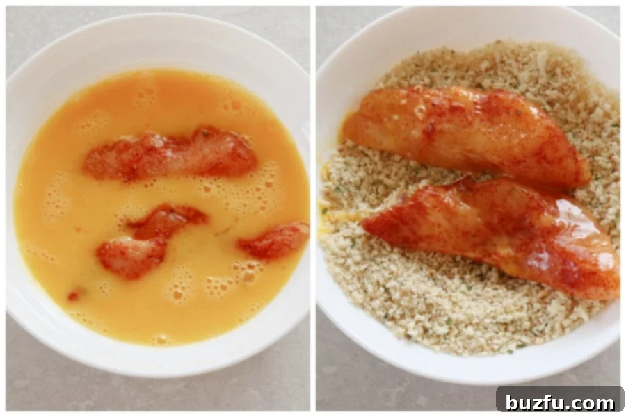 Chicken tenders being dipped into beaten eggs and then into a bowl of breadcrumbs for coating.