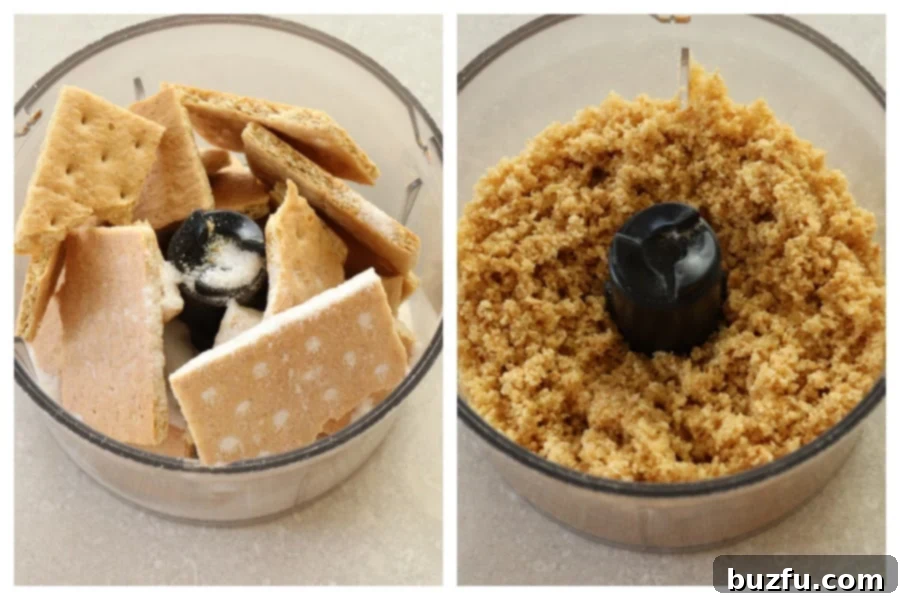 Close-up view of graham cracker crumbs being processed with sugar and melted butter in a mini food processor, forming the base for a cheesecake crust.