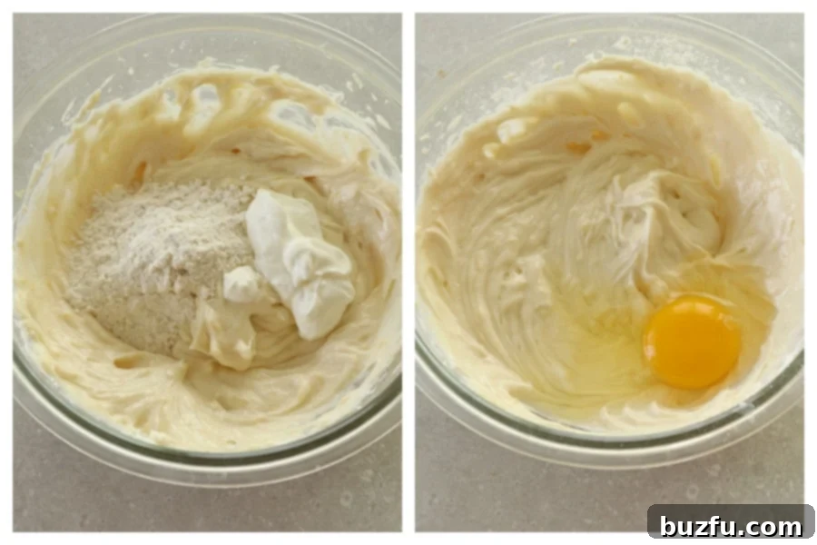Cheesecake filling in a glass bowl with flour and an egg freshly added, ready for final mixing before baking.