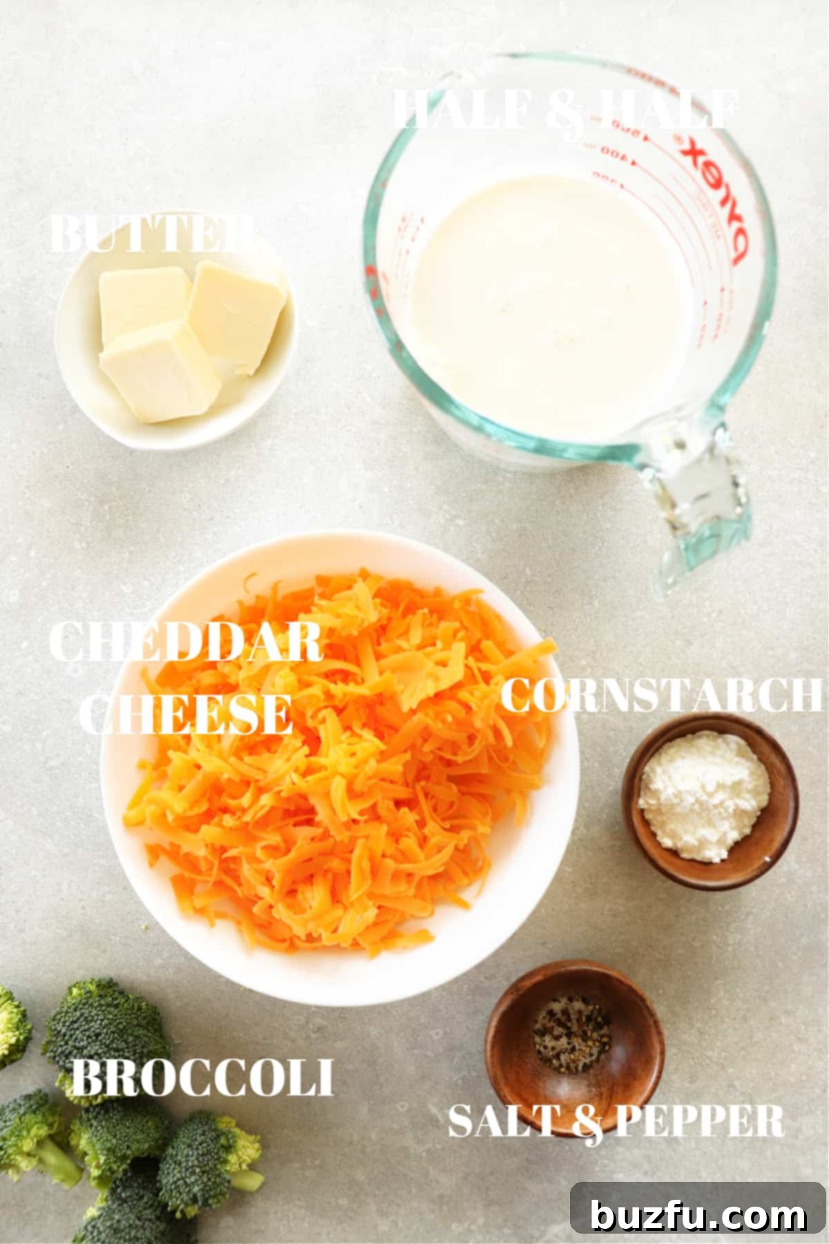 Key Ingredients for a Delicious Cheese Sauce Arrangement of fresh ingredients for making cheese sauce, including blocks of cheddar cheese, unsalted butter, half and half, cornstarch, and seasonings, neatly displayed on a rustic photography board.