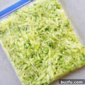 Shredded zucchini perfectly packaged in a freezer bag.