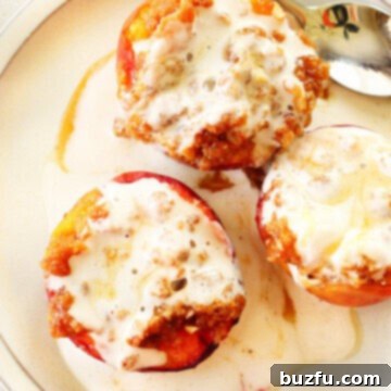 Sweet Air Fried Peaches 3 Three halves of peaches, beautifully air-fried and topped with whipped cream, presented on a white plate as the star of this recipe card.