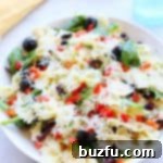 Pasta salad in a white bowl.