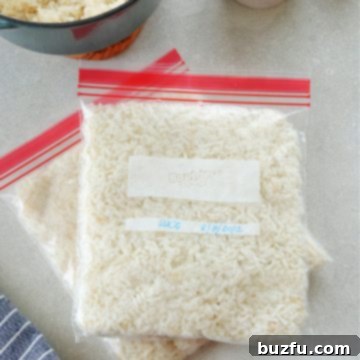 Unlock the Secret to Perfectly Frozen Rice 7 Cooked rice in freezer bags on a gray board with dried rice in a wooden bowl.